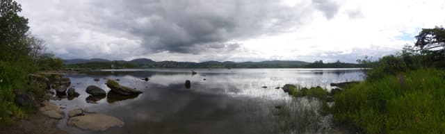 Wide view across the calm waters of Lough Eske towards distant hills