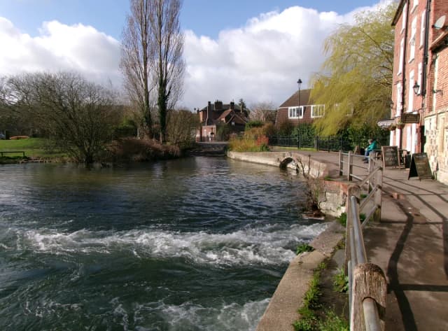 River Avon flowing past a weir near the Old Mill in Salisbury, Wiltshire