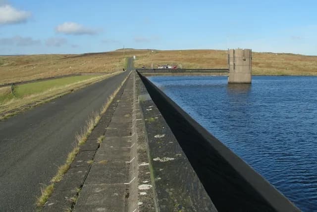 View across Dungonnell Reservoir standing on the reservoir wall, with hills in the background, County Antrim.