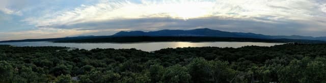 Panoramic view of Embalse de Valmayor reservoir with the Sierra de Guadarrama mountains in the background
