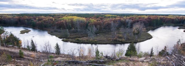Aerial view of the Au Sable River winding through forested banks in autumn, Michigan