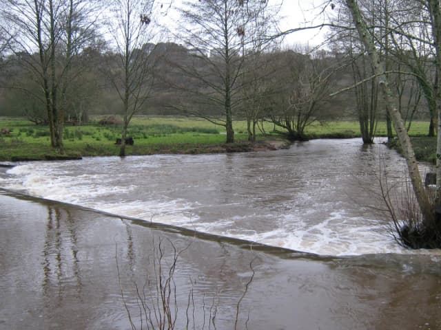 The Jet river in spate flowing over a weir, Ergué-Gabéric, Finistère