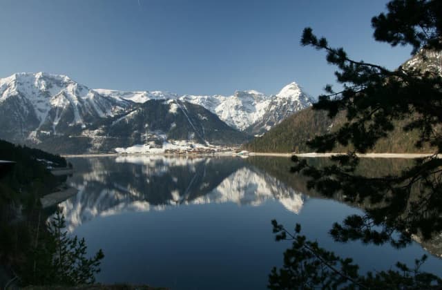View across Achensee lake toward the snow-capped Karwendel mountains near Pertisau, Austria