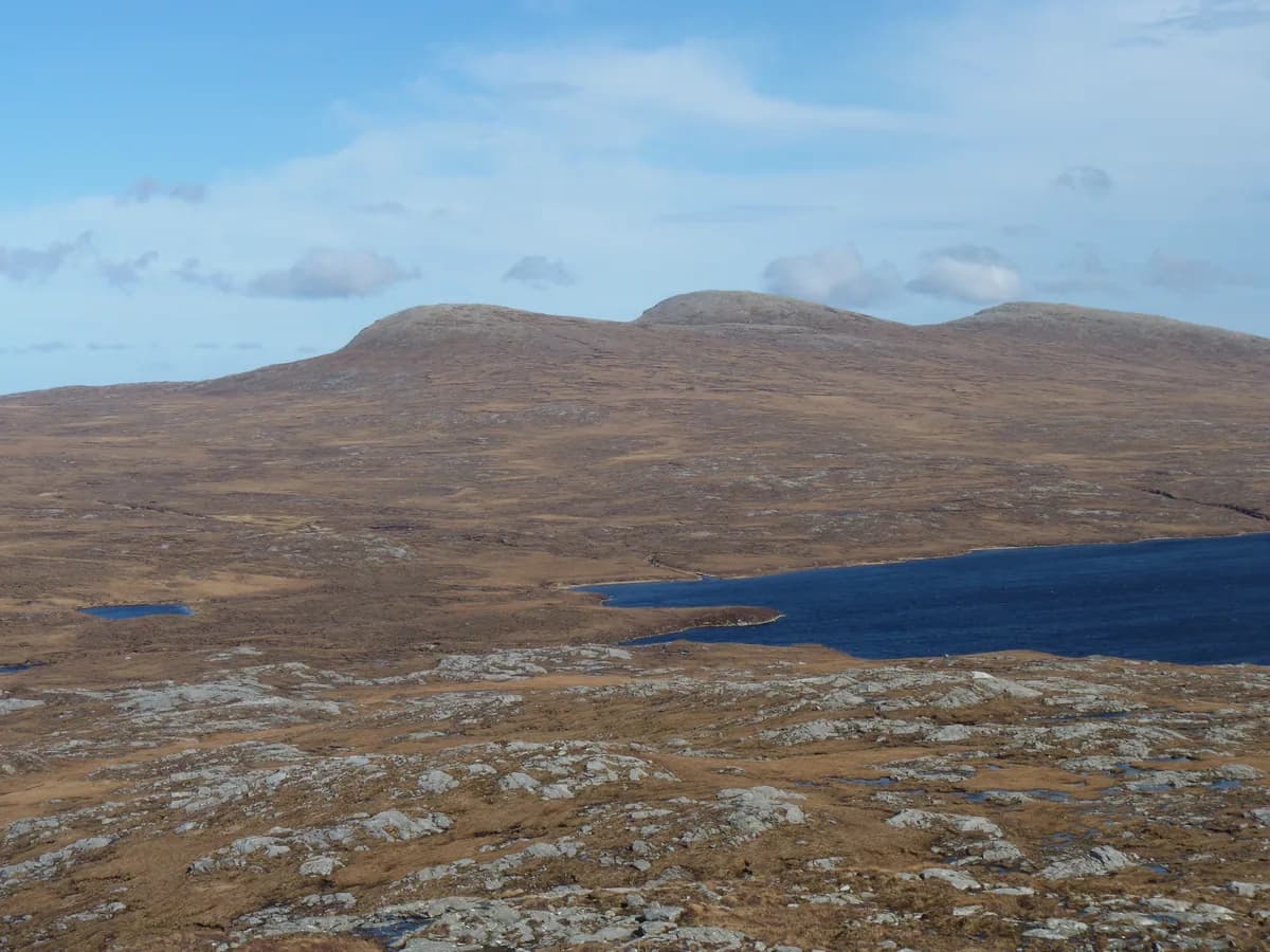 Loch na Craobhaig on the Isle of Lewis, a remote Hebridean hill loch with hills on the horizon.