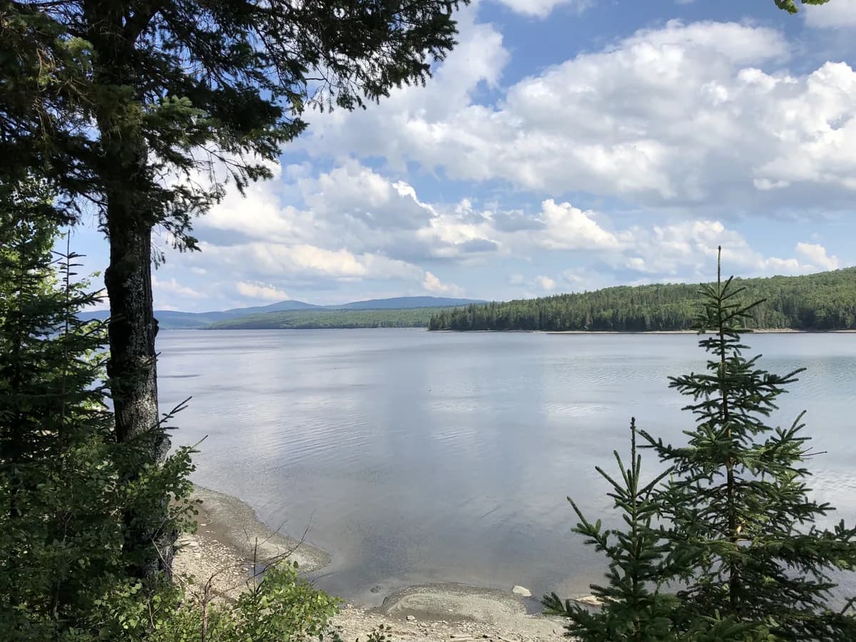 Wide view across Lake Francis, a reservoir on the upper Connecticut River, with forested hills and mountains in the background, Pittsburg, New Hampshire