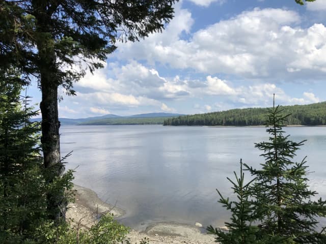 Wide view across Lake Francis, a reservoir on the upper Connecticut River, with forested hills and mountains in the background, Pittsburg, New Hampshire