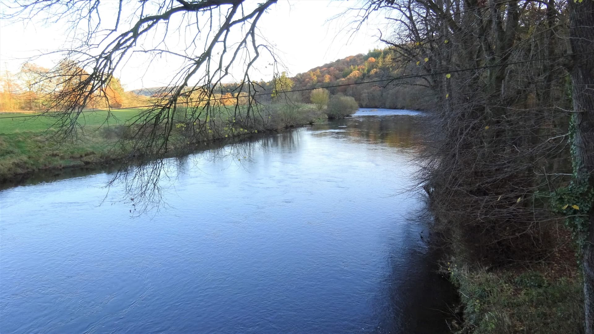 View upstream along the River Annan from Hoddom Bridge, the broad tree-lined river channel in Dumfriesshire.
