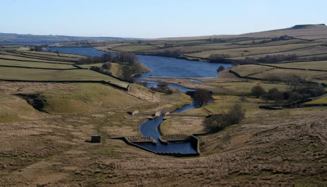 Aerial view of Blackton Reservoir in the Pennine hills of County Durham, with the River Balder feeding in through a stone-walled channel