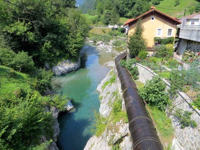 Crystal-clear turquoise Bača river flowing through a rocky limestone gorge at Klavže.