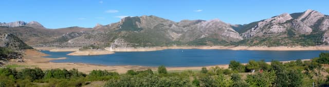 Panoramic summer view of Barrios de Luna reservoir with the Central Mountains of León on the far shore.