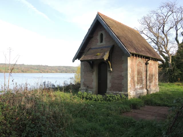 The Victorian pumping station on the shore of Blagdon Lake with open reservoir water behind it.