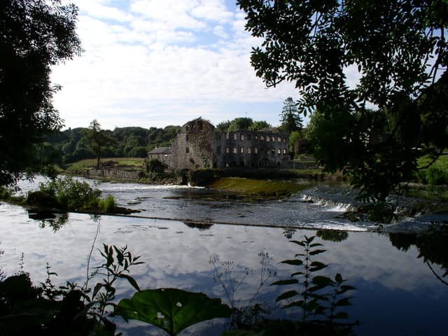 The old mill weir on the River Boyne at Stackallen, County Meath, white water over the stone sill.