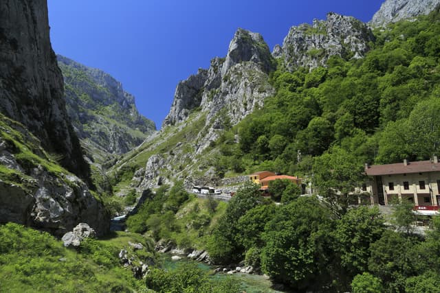 Poncebos at the foot of limestone pinnacles, the Río Cares a turquoise ribbon on the valley floor.