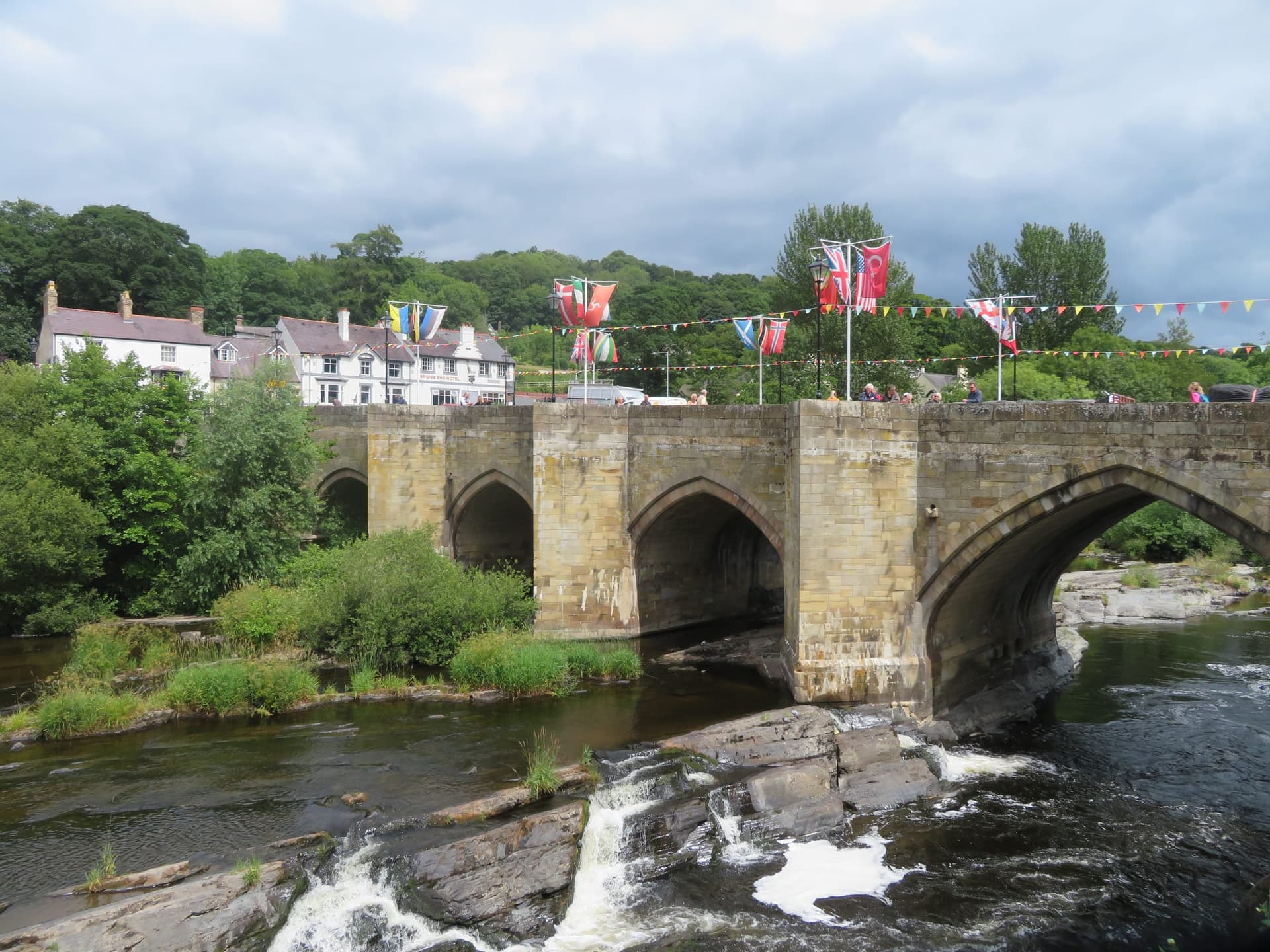 The River Dee (Afon Dyfrdwy) flowing through Llangollen in bright daylight, the river filling the foreground.