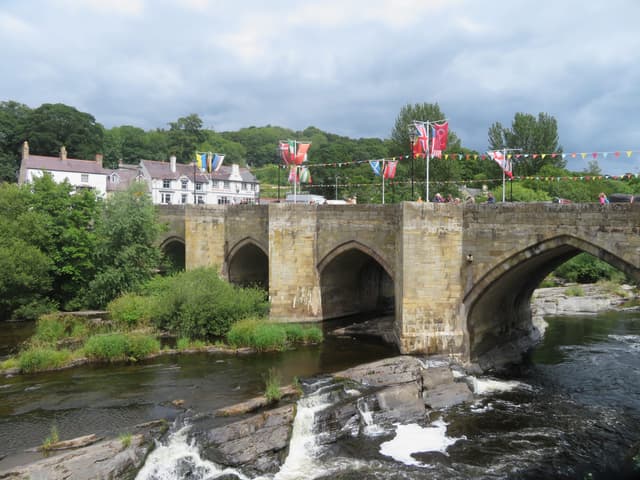 The River Dee (Afon Dyfrdwy) flowing through Llangollen in bright daylight, the river filling the foreground.