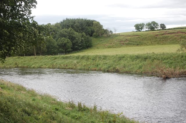 The River Deveron in the Marnoch parish, Aberdeenshire, a broad watercourse on a summer day.
