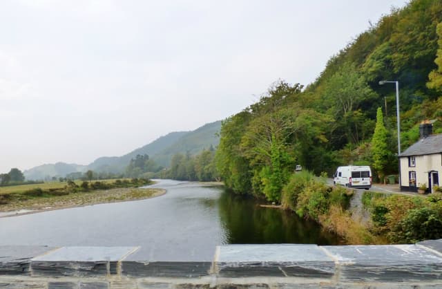 The Afon Dyfi flowing past a bridge near Machynlleth with Welsh hills in the background.