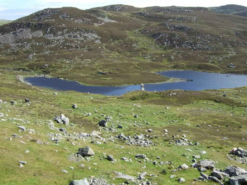 View across Sulma Water, a small freshwater loch on the West Mainland of Shetland, surrounded by rolling moorland.