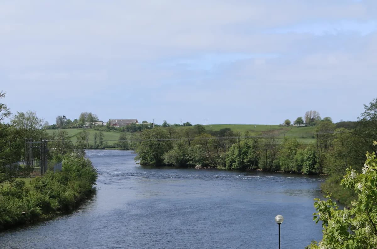 Wide view of the Lagan river flowing through farmland near Laholm, Halland, Sweden