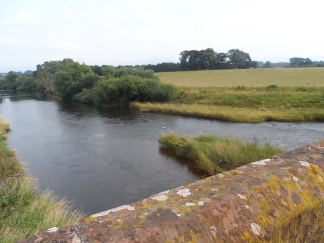 The River Eden viewed from Eden Bridge at Temple Sowerby in late summer, the clear channel prominent.