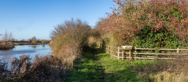Wide panoramic view across the open water of Farmoor Reservoir, Oxfordshire.