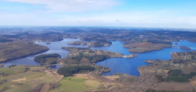 Aerial view of Lac de Vassivière reservoir with wooded peninsulas and islands, Plateau de Millevaches, France