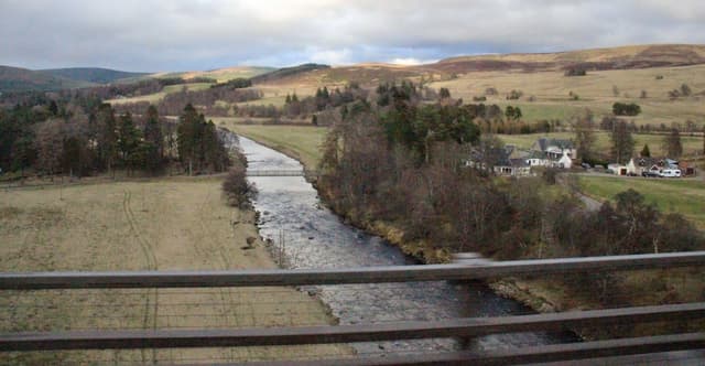 A wide view of the River Findhorn running through open moorland at Tomatin in the upper reaches.