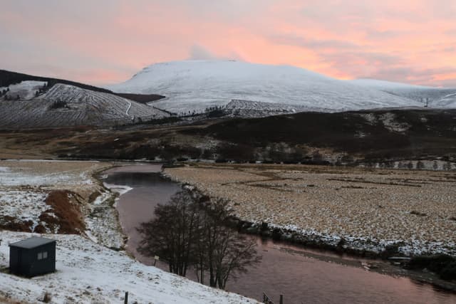 The River Helmsdale flowing over rocky shallows at Duible in the upper Kildonan glen, moorland hills behind.