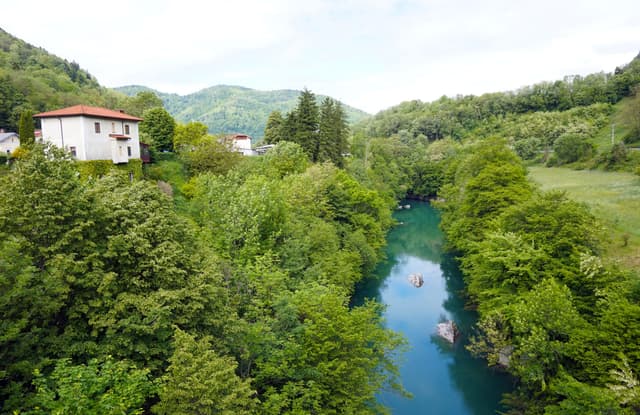 The Idrijca river near Most na Soči, Slovenia, with clear green water.