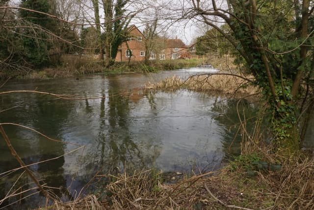 The River Itchen at Itchen Abbas running full through several braided chalkstream channels.