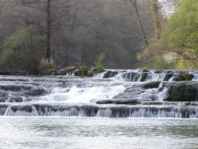 A tufa barrier across the Krka at Žužemberk, the river flowing over the natural dam.