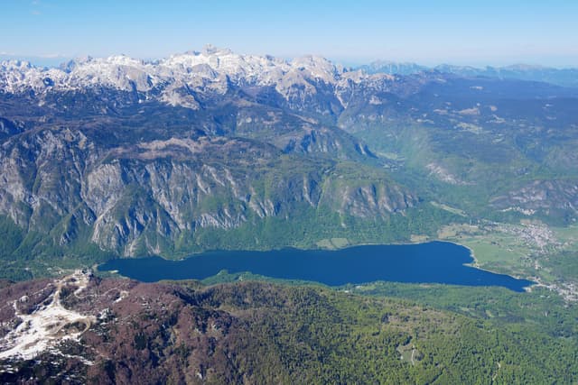 Aerial view of Lake Bohinj looking south, the whole glacial lake against the Julian Alps and Triglav.