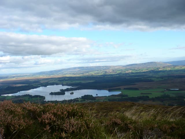 Elevated view of the Lake of Menteith from the Menteith Hills, the open water ringed by rolling uplands.