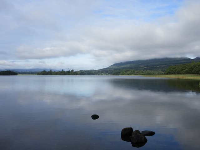 Early-morning mirror-calm surface of the Lake of Menteith looking westward in still conditions.