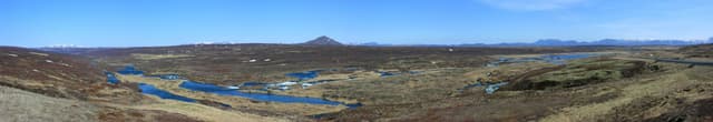 Panoramic view of the Laxárdalur valley with the Laxá í Aðaldal running through a wide green valley.