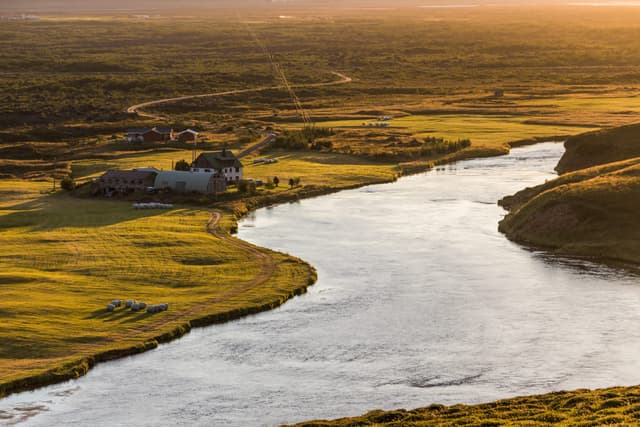 The Laxá í Aðaldal forming pronounced meanders through a flat Icelandic river valley.