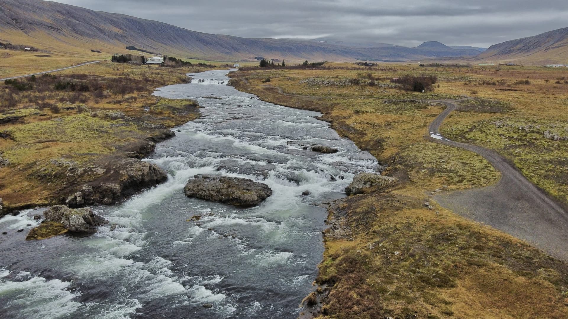 Aerial drone view of rapids on the Laxá í Kjós just before its mouth at Laxárvogur bay, Iceland.