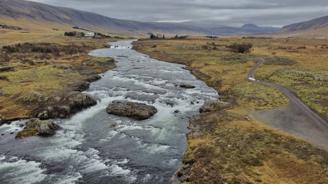 Aerial drone view of rapids on the Laxá í Kjós just before its mouth at Laxárvogur bay, Iceland.