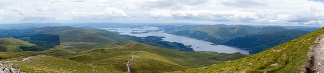 Panoramic view of Loch Lomond and its scattered islands from the slopes of Ben Lomond, the loch stretching south.