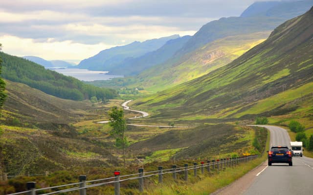 A wide panoramic view looking down toward the open expanse of Loch Maree in the Northwest Highlands.