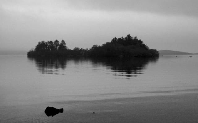 Illaunaknick Island on North Lough Corrib under a dramatic sky, open water surrounding it.