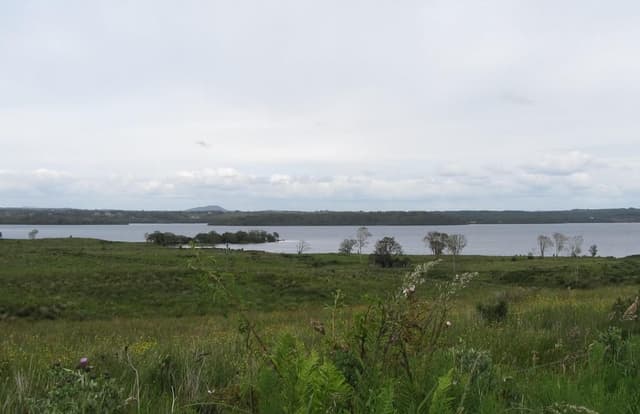 Broad view of Lough Melvin from the R281 at Bomahas, open water stretching to distant hills.