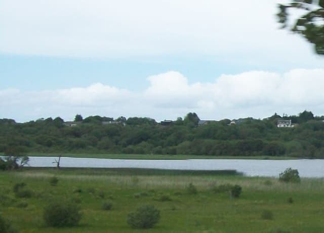 The western end of Lough Melvin near Kinlough, open lough water with meadows and Garrison across the water.