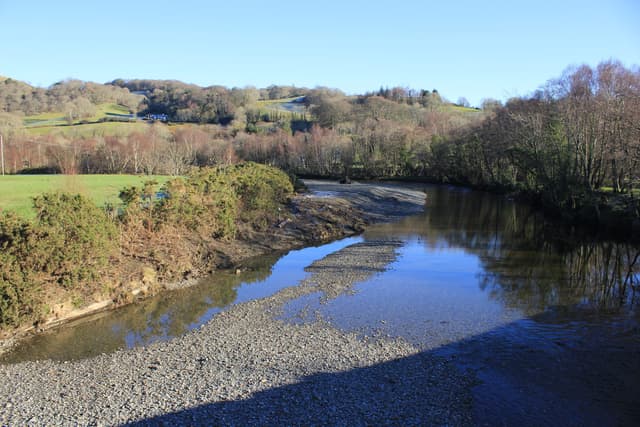 The Afon Mawddach at Llanelltyd with the river dominating the foreground and wooded hills beyond.