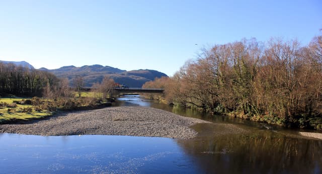 The Afon Mawddach flowing through the valley at Llanelltyd, looking upriver with wooded hillsides on the banks.