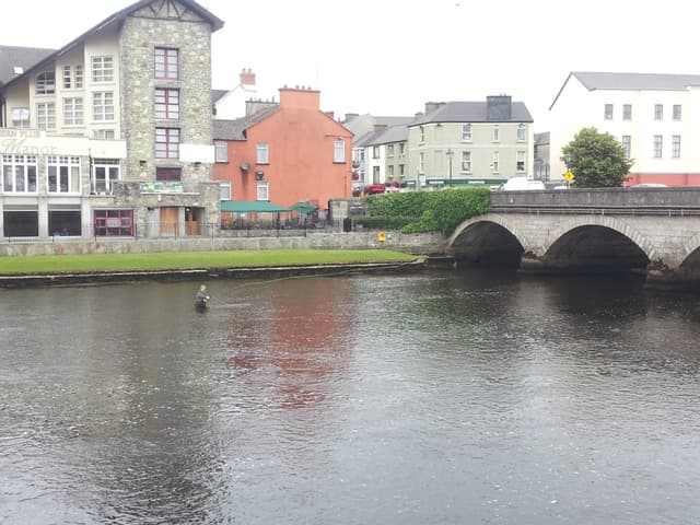 Fly fisherman casting on the River Moy at Ballina, County Mayo.