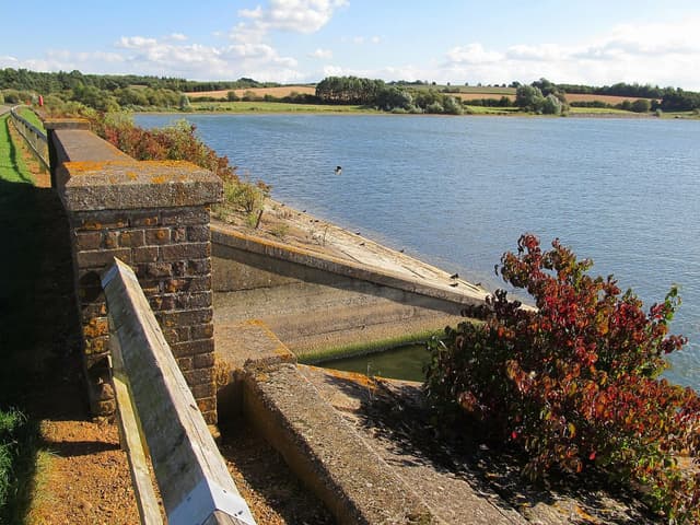The Brixworth Road causeway crossing Pitsford Reservoir with water on both sides.