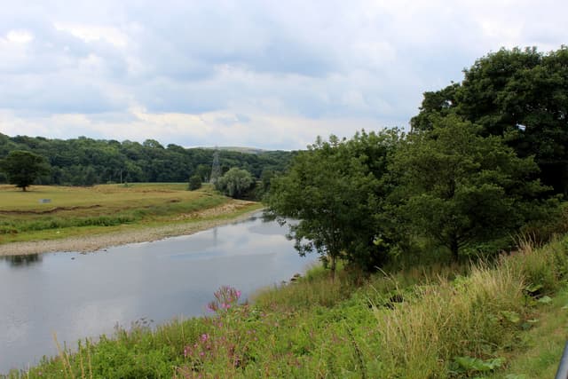 Wide view of the River Ribble at Ribchester showing gravelly shallows and summer low-water riffles.