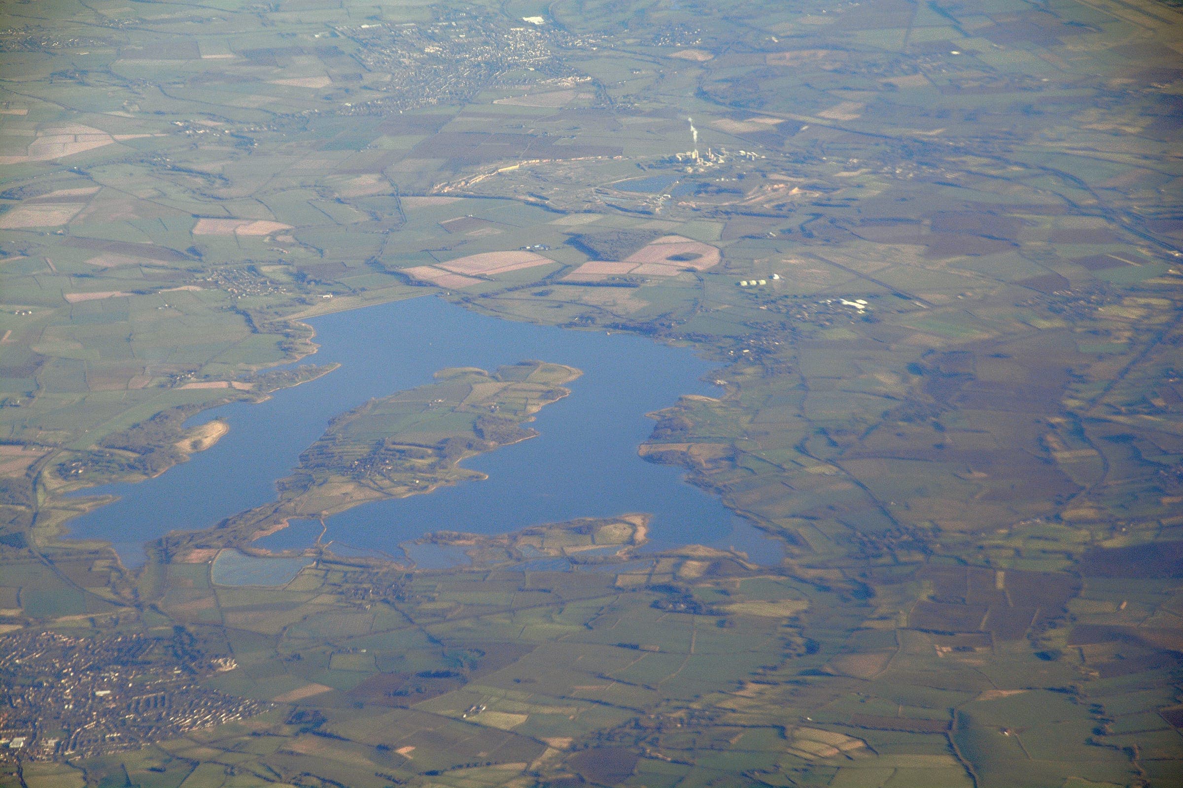High-altitude aerial view of Rutland Water reservoir showing the full horseshoe-shaped impoundment.