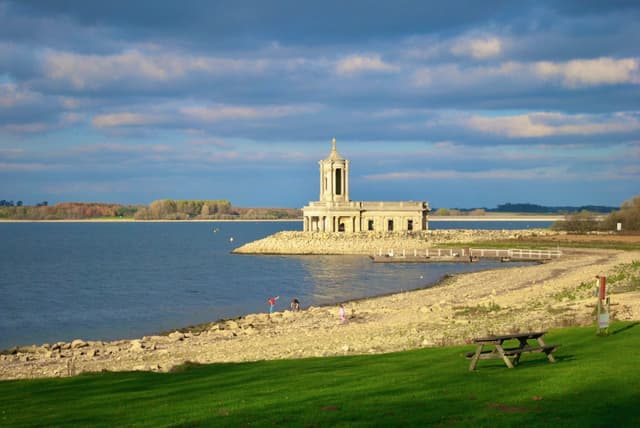 Normanton Church standing in the shallows of Rutland Water with the reservoir stretching to the horizon.